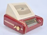 a red and white radio sitting on a white surface