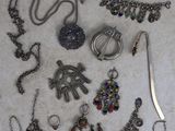 a lot of necklaces and bracelets laid out on the floor
