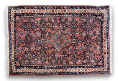an antique persian rug with a red and blue design