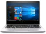 the laptop is open on a white surface with windows on the screen