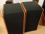 two speakers that are sitting on a wooden table