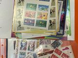 a lot of stamps on a table with a book