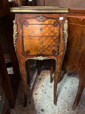 a small wooden table with a mirror on top of it