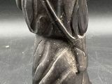 a statue of a woman holding a baby on her back