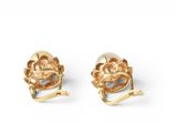 a pair of gold tone earrings with a flower design