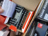 a box full of electronic equipment and a person holding a piece of paper