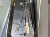 a tray with a bunch of surgical tools in it