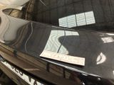 a sticker on the hood of a car that is parked in a parking lot