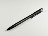 a black pen that is laying on a white surface