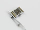 a small metal object with a clock on top of it