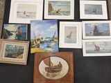 many framed pictures of boats on a table