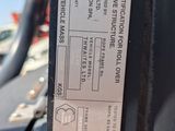 a label on the back of a truck that is parked on the side of the road