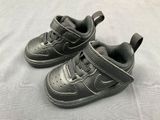 a pair of baby shoes that are on a bed