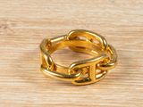 an image of a gold ring on a wooden surface