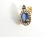 an image of a blue sapphire and diamond ring on a white surface