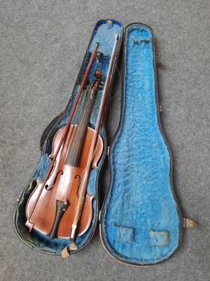 a violin and a violin case on the floor