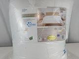 a pillow that is wrapped in plastic on a table