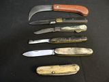 several different types of knives are lined up on a black surface