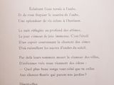 an open book with a poem written in french on it