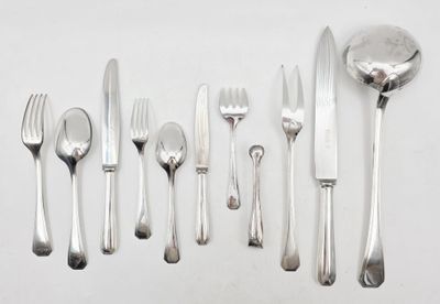 a lot of silverware on a table with a spoon and fork