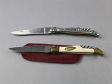 two knives that are sitting next to each other on a table