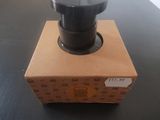a box with a black knob on it on a table
