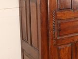 a wooden cabinet with a door on top of it