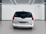 the back end of a white van parked in a white room