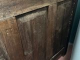 a wooden door with a wooden top in a room