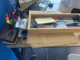 a desk with a computer, keyboard, mouse, and other office supplies on it