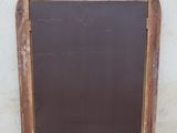 a chalk board on the sidewalk next to a wall