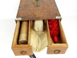 a wooden box with two drawers and a feather in it