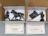two boxes with two figurines of horses in them