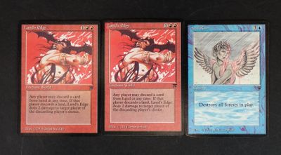 three cards with different designs on them on a black surface