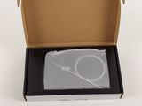 an open cardboard box with a white object inside of it on a white surface