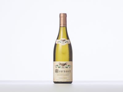 a bottle of white wine sitting on top of a table