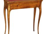 a wooden table with a red leather top on a white background