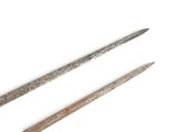 pair of old iron nails on a white surface with a white background