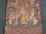 a picture of a tapestry on the floor next to a pair of shoes