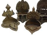 a group of brass objects that are sitting on a white surface
