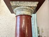 a statue of a man sitting on top of a pedestal