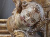 a close up of a statue of a child on a chair