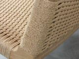 a wooden chair with a woven seat and arm rest