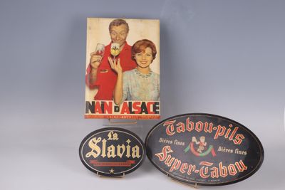 two advertising signs and a box of cigarettes on a table