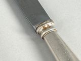 a silver knife and a silver spoon on a table