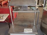 a table that has a metal shelf on top of it