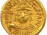 une pièce d'or sur laquelle est représenté le visage d'un homme