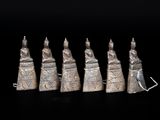 five silver figurines of people in the form of hands