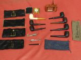 a lot of different types of smoking pipes on the table