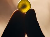 a person holding a piece of glass in their hand